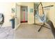 Exterior door leading to interior with swing and decor on patio at 209 Arlington E Ave, Oldsmar, FL 34677