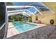 Enclosed swimming pool with tile surround and seating areas at 209 Arlington E Ave, Oldsmar, FL 34677