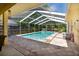 Enclosed swimming pool with tile surround and seating areas at 209 Arlington E Ave, Oldsmar, FL 34677
