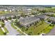 Aerial showcasing townhomes with attached garages, lush landscaping and ponds in a well-maintained community at 2227 Golden Falcon Dr, Ruskin, FL 33570