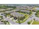 Aerial view of townhomes featuring lush landscaping, attached garages, and community ponds in a well-maintained neighborhood at 2227 Golden Falcon Dr, Ruskin, FL 33570