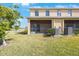 Backyard view with screened in patio and lush green grass at 2227 Golden Falcon Dr, Ruskin, FL 33570
