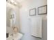 Elegant bathroom with a stylish oval mirror, decorative wall art, and a fresh, inviting ambiance at 2227 Golden Falcon Dr, Ruskin, FL 33570