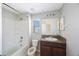 Bathroom features a shower-tub combination, vanity and a window at 2227 Golden Falcon Dr, Ruskin, FL 33570
