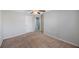 Empty bedroom with ceiling fan, carpet flooring, and a door leading to the bathroom at 2227 Golden Falcon Dr, Ruskin, FL 33570