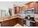 Close-up of a kitchen with granite countertops, stainless appliances, and classic cabinetry, ready for culinary adventures at 2227 Golden Falcon Dr, Ruskin, FL 33570