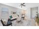 Bright living room showcasing neutral décor, tile floors, and natural light from the windows with comfortable seating at 2227 Golden Falcon Dr, Ruskin, FL 33570