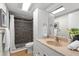 Bathroom featuring a tiled shower, vanity with sink, and modern fixtures at 2257 Lake Dr, Dunedin, FL 34698