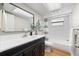 Well-lit bathroom featuring a modern vanity, large mirror, and shower-tub combination at 2257 Lake Dr, Dunedin, FL 34698