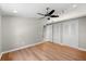 Cozy bedroom with hardwood floors, ceiling fan, closet space, and ample natural light at 2257 Lake Dr, Dunedin, FL 34698