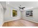 Bright bedroom with hardwood floors, ceiling fan, and natural light from two windows at 2257 Lake Dr, Dunedin, FL 34698