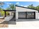 Home exterior features a modern design with a black garage door, white siding, and a covered front porch at 2257 Lake Dr, Dunedin, FL 34698