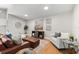 Cozy living area with neutral walls, modern decor, hardwood floors and comfortable seating arrangements at 2257 Lake Dr, Dunedin, FL 34698