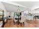 Open living space featuring dining area and kitchen with hardwood flooring and ample natural light at 2257 Lake Dr, Dunedin, FL 34698