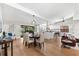 Open-concept living and dining area with hardwood floors, a modern kitchen, and natural light throughout at 2257 Lake Dr, Dunedin, FL 34698