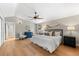 Bright main bedroom with hardwood floors, a ceiling fan, and abundant natural light at 2257 Lake Dr, Dunedin, FL 34698