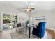 Bright home office with stylish decor, a ceiling fan, and sliding door access to the exterior at 2257 Lake Dr, Dunedin, FL 34698