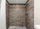 Modern shower stall featuring decorative brown tile surround and mosaic accents at 2257 Lake Dr, Dunedin, FL 34698