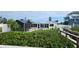 Manicured backyard featuring access to both the screen lanai and waterfront at 3302 W Shell Point Rd, Ruskin, FL 33570