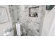 Bathroom features a fully-tiled glass shower with built-in shelving for toiletries and decorative accents at 3302 W Shell Point Rd, Ruskin, FL 33570