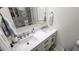 Modern bathroom with double sinks, white cabinets, and brushed nickel hardware for a clean and stylish look at 3302 W Shell Point Rd, Ruskin, FL 33570
