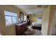 Bright bedroom with large windows, a ceiling fan, and a comfortable bed with a patterned comforter at 3302 W Shell Point Rd, Ruskin, FL 33570
