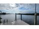 Scenic view from the private dock showcasing tranquil waterfront living with a dock ladder and beautiful skies at 3302 W Shell Point Rd, Ruskin, FL 33570
