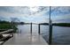 Scenic view from the private dock showcasing tranquil waterfront living with a dock ladder and beautiful skies at 3302 W Shell Point Rd, Ruskin, FL 33570