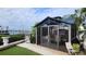 Relaxing screened-in lanai overlooking the waterfront with tropical landscaping at 3302 W Shell Point Rd, Ruskin, FL 33570