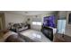 Inviting living room with a large flat-screen TV, comfortable seating, and windows, ideal for relaxation at 3302 W Shell Point Rd, Ruskin, FL 33570