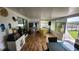 Bright and inviting sunroom featuring tile floors, an entertainment area, and access to the outdoor space at 3302 W Shell Point Rd, Ruskin, FL 33570