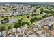 Stunning aerial view of the property, nestled within a vibrant community with golf courses and scenic ponds at 336 Northway Dr, Sun City Center, FL 33573