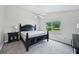 Cozy bedroom with a ceiling fan, comfortable carpeting, and large window allowing natural light at 336 Northway Dr, Sun City Center, FL 33573