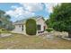 Beige home with trees, colorful flowers and a low maintenance yard at 336 Northway Dr, Sun City Center, FL 33573