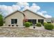 Beige home with colorful flowers, trimmed bushes and a low maintenance yard at 336 Northway Dr, Sun City Center, FL 33573
