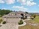 Charming single-story home with a neutral color scheme, arched entryway, brick paver driveway, and attached two-car garage at 336 Northway Dr, Sun City Center, FL 33573