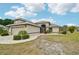 Charming home featuring a two-car garage, decorative details, and a well-maintained lawn at 336 Northway Dr, Sun City Center, FL 33573