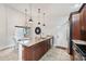 Kitchen island with granite countertops, stainless steel appliances, and dining area with chandelier at 336 Northway Dr, Sun City Center, FL 33573