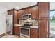 Updated kitchen with stainless appliances, granite countertops, and ample dark wood cabinetry at 336 Northway Dr, Sun City Center, FL 33573