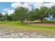 Expansive green and sandy backyard with mature trees perfect for outdoor activities at 336 Northway Dr, Sun City Center, FL 33573