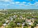 Expansive aerial view of a neighborhood filled with lush green trees and glimpses of the bay in the distance at 3408 W San Jose St, Tampa, FL 33629