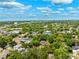 Scenic aerial view highlighting a peaceful residential area with mature trees and a water tower on the horizon at 3408 W San Jose St, Tampa, FL 33629
