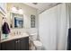 Well-lit bathroom featuring a vanity with granite counter and a shower with subway tile at 3408 W San Jose St, Tampa, FL 33629