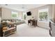 Bright bedroom featuring a comfortable couch, sleek desk, and plenty of natural light from the large windows at 3408 W San Jose St, Tampa, FL 33629