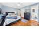 Cozy bedroom with hardwood floors, a comfortable bed, and easy access to a private bathroom at 3408 W San Jose St, Tampa, FL 33629