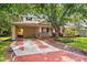 Charming home featuring a brick driveway, carport, and a cozy front porch at 3408 W San Jose St, Tampa, FL 33629