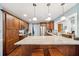 Spacious kitchen with a large granite island, stainless steel appliances, and custom wood cabinets at 3408 W San Jose St, Tampa, FL 33629