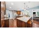 Bright kitchen with a large granite island, stainless steel appliances, and custom wood cabinets at 3408 W San Jose St, Tampa, FL 33629