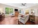 Bright living room with hardwood floors, large windows, comfortable seating, and stylish furnishings at 3408 W San Jose St, Tampa, FL 33629