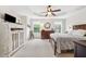Serene main bedroom with tray ceilings, a ceiling fan, hardwood furniture, and natural light at 3408 W San Jose St, Tampa, FL 33629